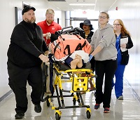 Students enrolled in all of East Mississippi Community College’s Division of Nursing and Allied Health programs took part in a large-scale simulation in which a patient suffering a medical emergency was transported by paramedics and emergency medical technicians to the emergency room and sent to a catheterization lab before winding up in the operating room.