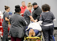 Students enrolled in East Mississippi Community College’s Division of Nursing and Allied Health participate in a March medical emergency simulation prior to the outbreak of the coronavirus. A drive-by graduation for students in the Paramedic, Practical Nursing and Surgical Technology programs will take place July 25.