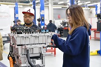 Izzy Latham, at right, a May graduate of East Mississippi Community College’s Automotive Technology program, works on an electric motor during a class training session last year along with her classmate, Reggie Roberson. 