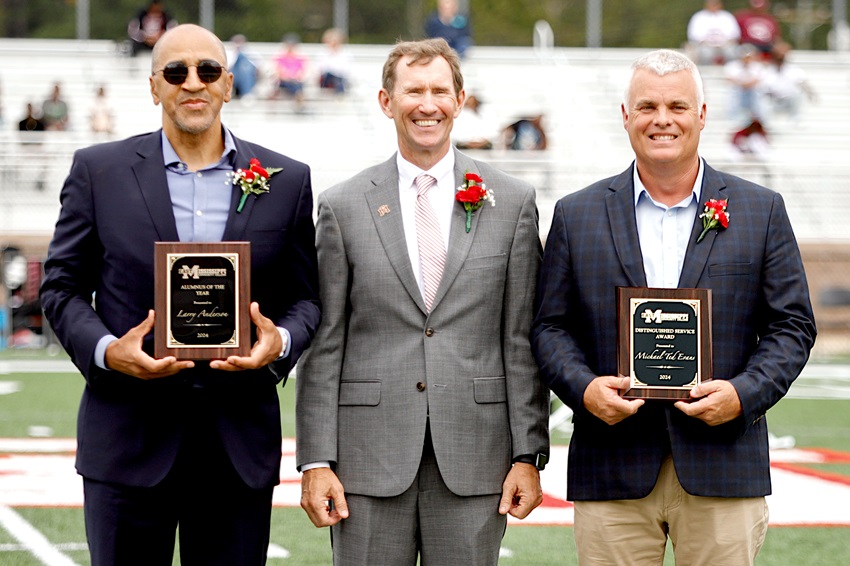 East Mississippi Community College President Dr. Scott Alsobrooks, center, presents Larry Anderson, at left, with the 2024 Alumnus of the Year Award, and Michael Ted Evans, at right, with the 2024 Distinguished Service Award during halftime of the college’s Sept. 28 Homecoming football game. 