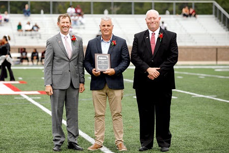 Kemper County native Michael Ted Evans, center, is East Mississippi Community College’s 2024 Distinguished Service Award recipient. He was recognized during halftime of the college’s Sept. 28 Homecoming football game by EMCC President Dr. Scott Alsobrooks, at left, and Dean of Scooba Campus/College Advancement Tony Montgomery.