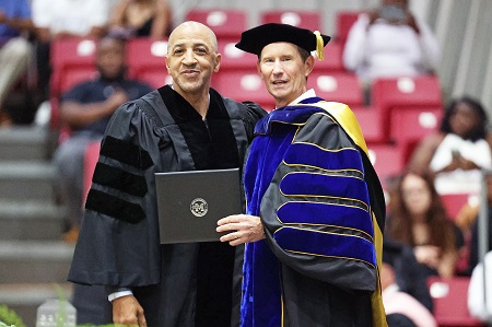 East Mississippi Community College President Dr. Scott Alsobrooks, at right, presents Massachusetts Institute of Technology head basketball coach Larry Anderson with his diploma during a May 11 graduation ceremony on the college’s Scooba campus. Anderson, the guest speaker during EMCC spring graduation ceremonies, earned degrees from Rust College and the University of Mississippi but had not completed his degree from EMCC when he left the school in 1983. 