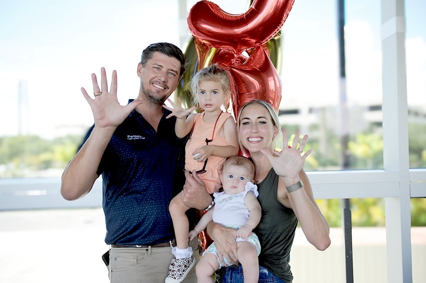 EMCC alumnus Jonathan Russell, at left, is pictured here with his wife, Nicollette, and their daughters, Abbigail Jean and Addilyn Sue. Russell is president and CEO of Florida-based Partners Development & Construction Group. 