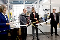 East Mississippi Community College President Dr. Scott Alsobrooks, second from right, and Mississippi State University President Dr. Mark E. Keenum, second from left, cut the ribbon Jan. 29 for the official unveiling of the Advancements in Manufacturing Upskilling Program, or AiM UP, at The Communiversity. They were assisted by MSU Vice President for Research and Economic Development Julie Jordan, at left, and EMCC Vice President of Career Technical and Workforce Education Dr. Michael Busby, at right.